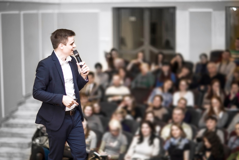 man giving presentation in a suit