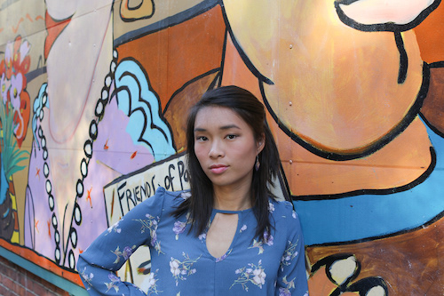 Nicole Leung in front of a mural in seattle, washington